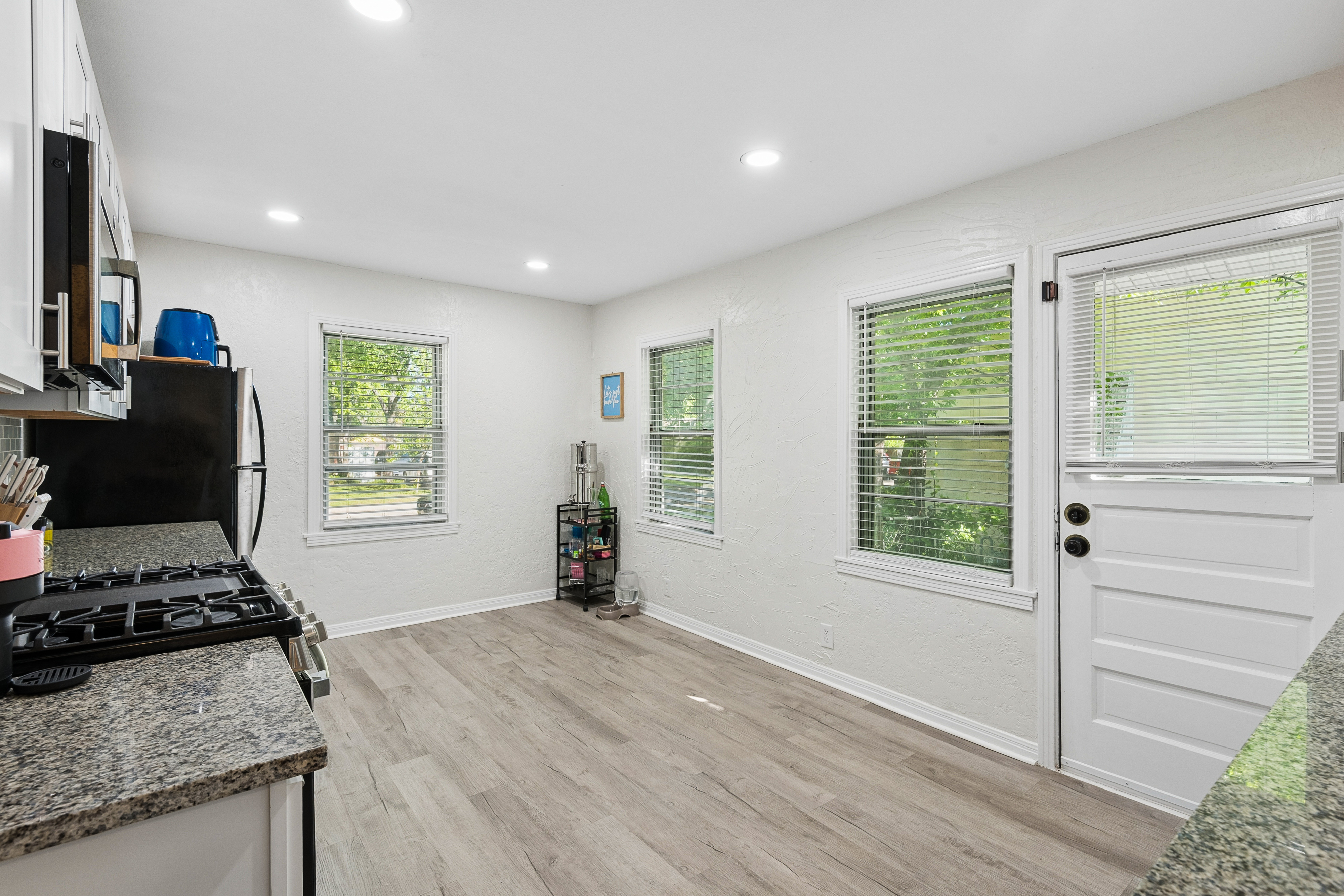 Kitchen with white cabinets and hardwood floors at 2821 S Hills Ave