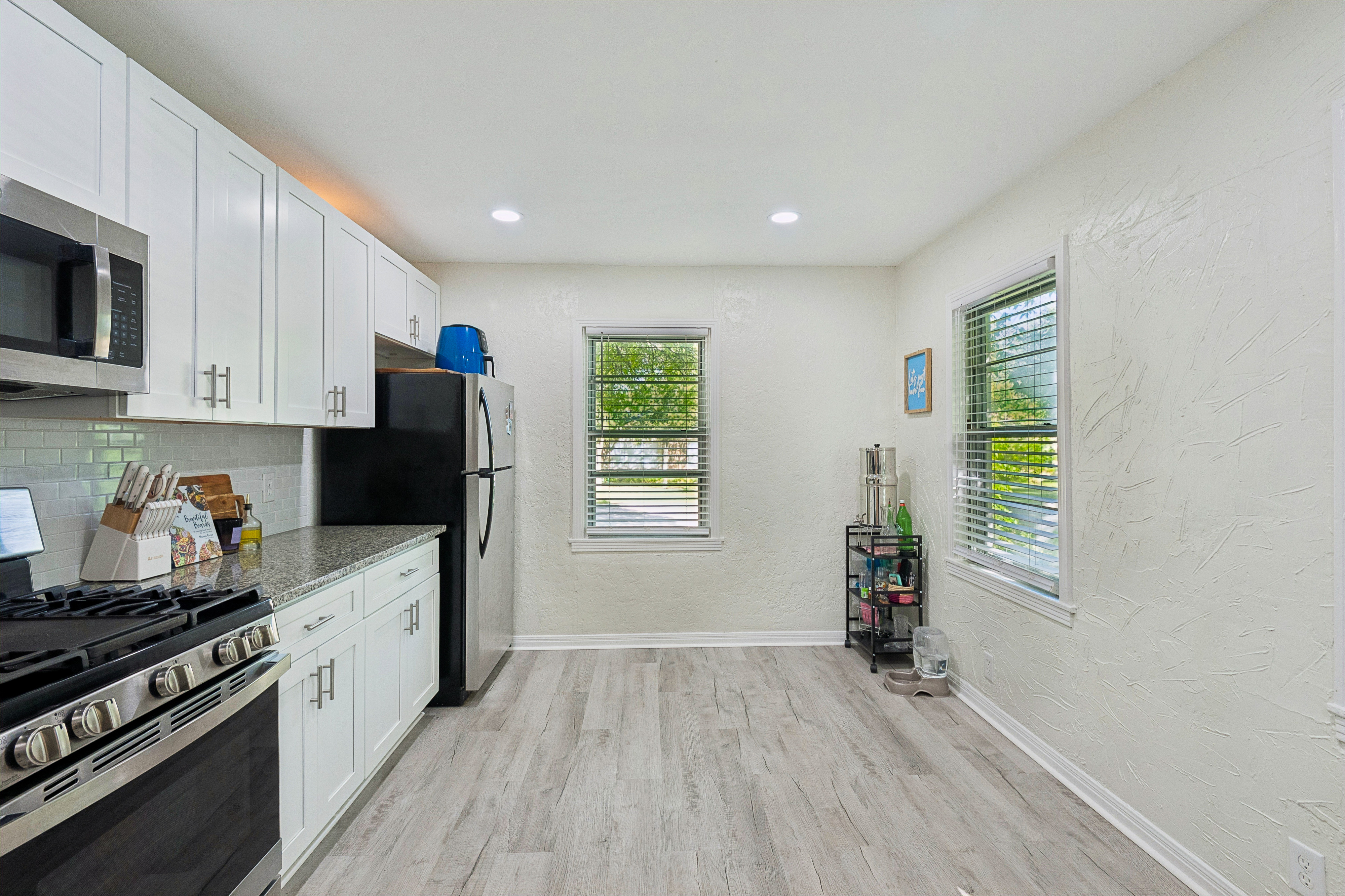 Kitchen with white cabinets and hardwood floors at 2821 S Hills Ave