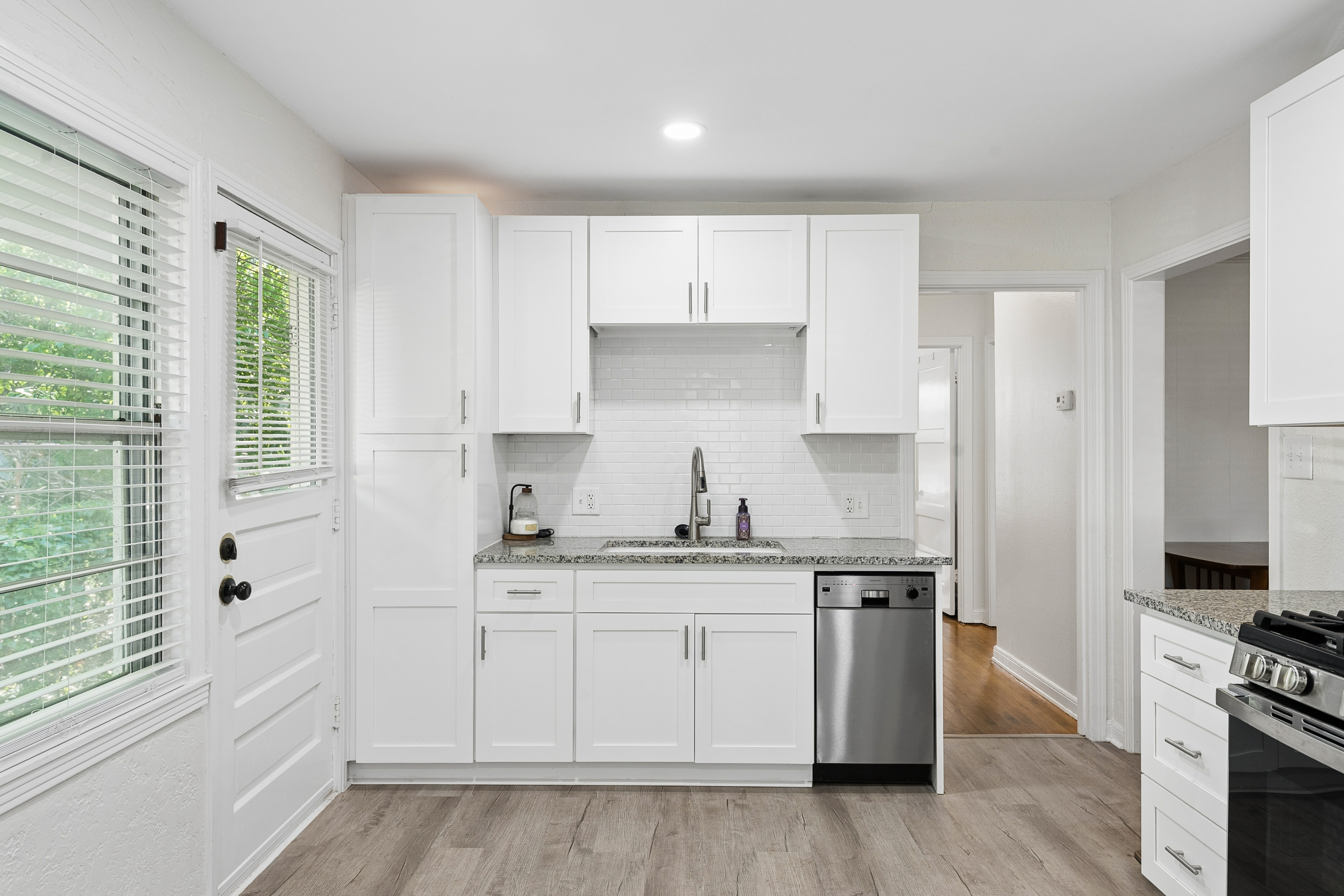 Kitchen with white cabinets and hardwood floors at 2821 S Hills Ave