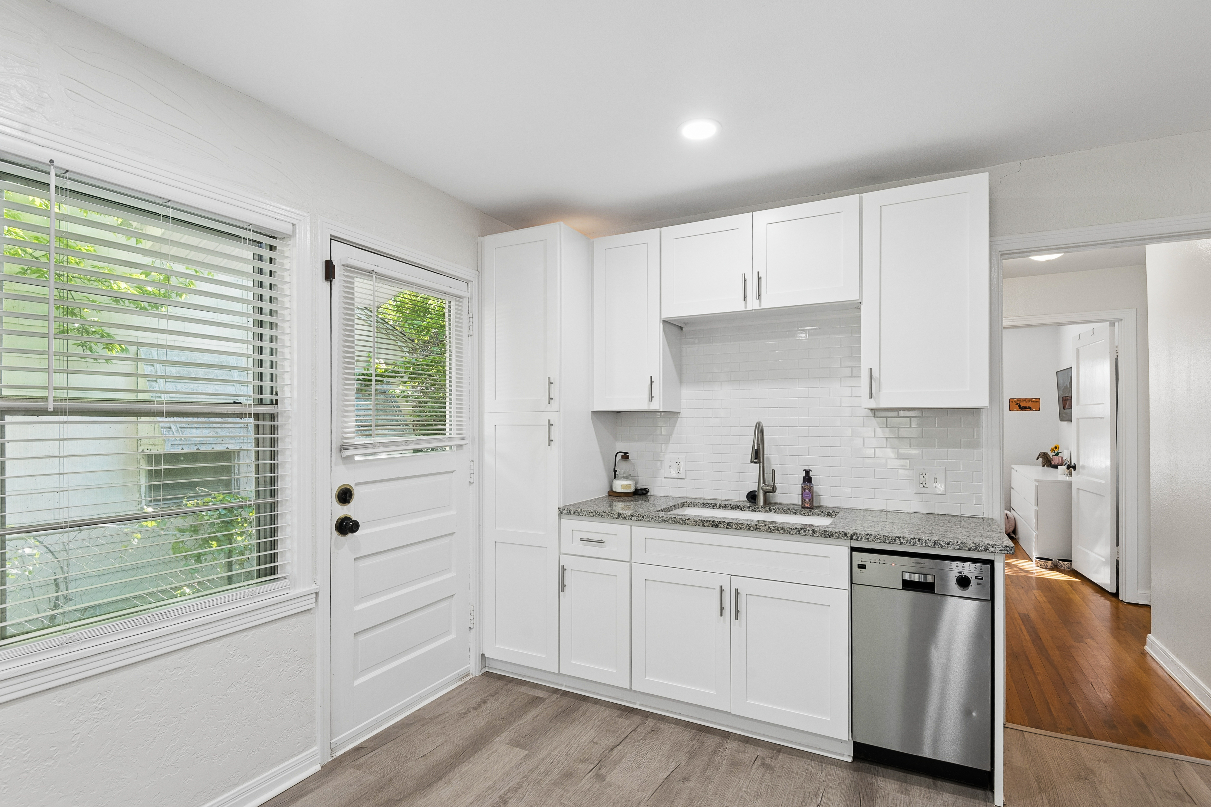 Kitchen with white cabinets and hardwood floors at 2821 S Hills Ave